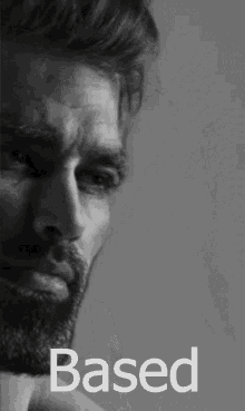 Close-up of a serious man with a beard, highlighting facial contours and expression in monochrome.
